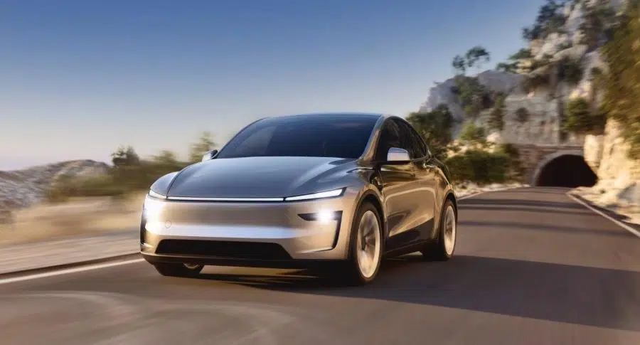 Tesla Model Y electric SUV driving on a suburban road