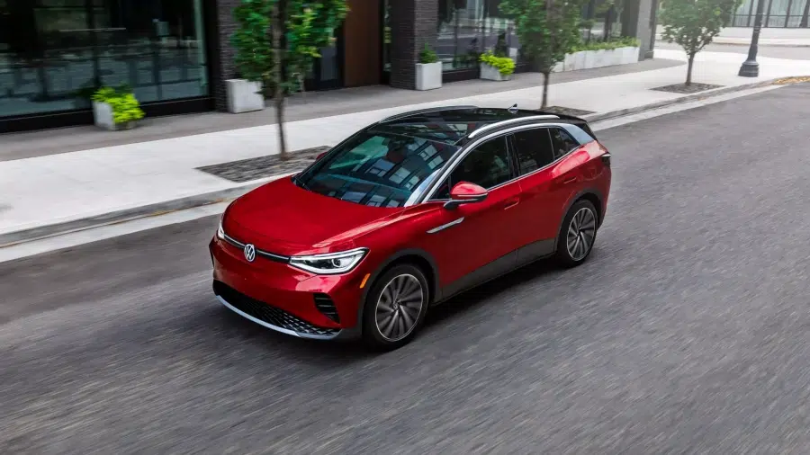 Volkswagen ID.4 electric SUV driving on a European city street, compact crossover EV with modern design